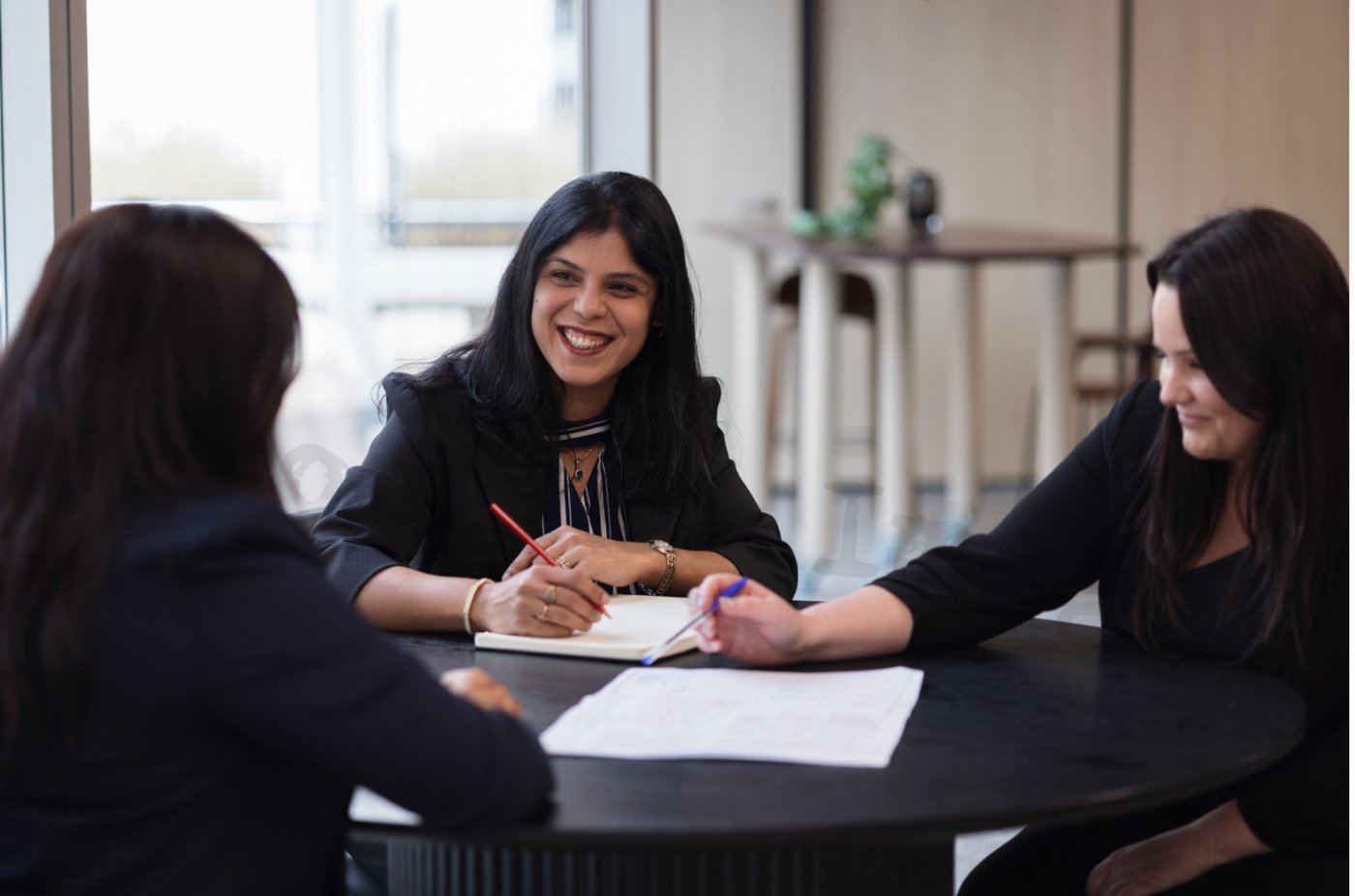 Iti Mehrotra in a strategy session with two clients