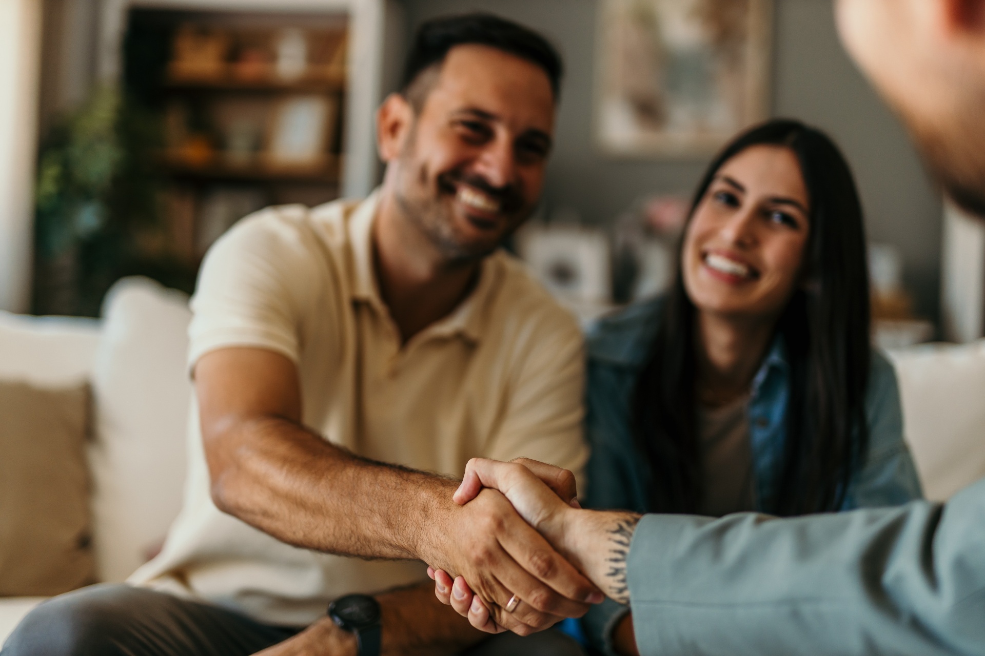 Couple shaking hands with mortgage broker